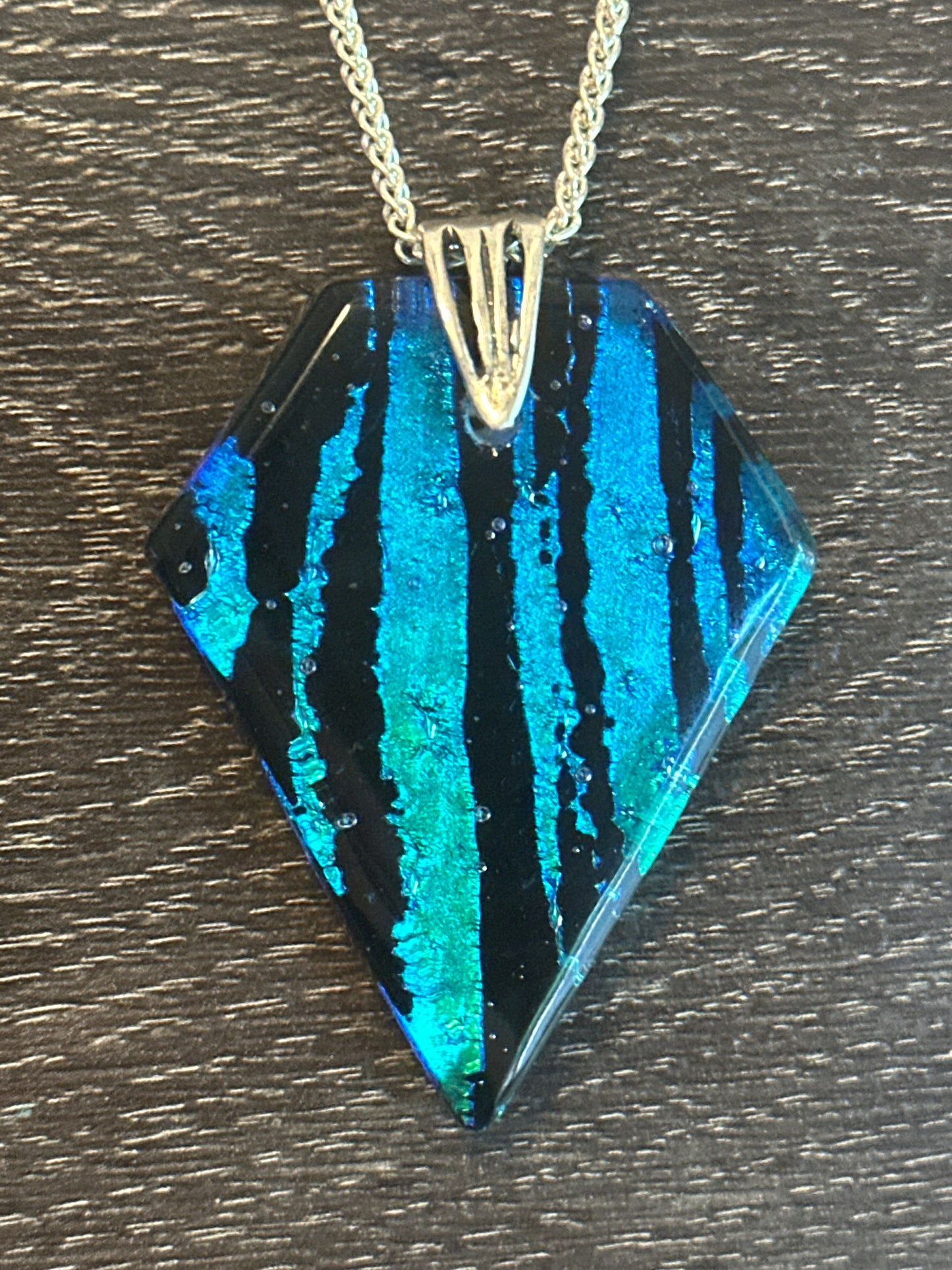 Hand etched and fused blue, teal, green and black multicolor dichroic glass pendant with sterling silver bail and wheat chain.