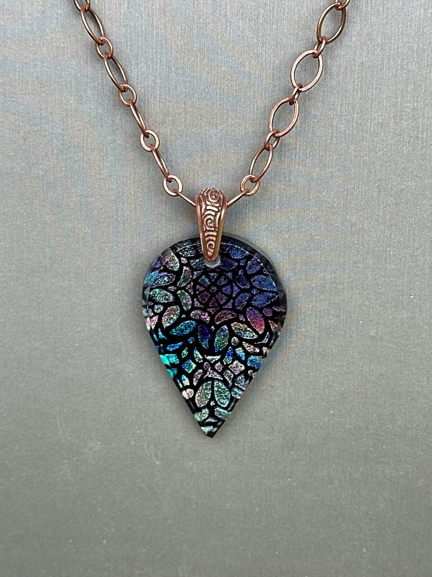 Hand etched and fused blue multicolor teardrop dichroic glass pendant with stained glass appearance.