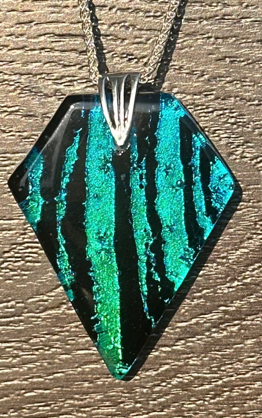 Hand etched and fused blue, teal, green and black multicolor dichroic glass pendant with sterling silver bail and wheat chain.