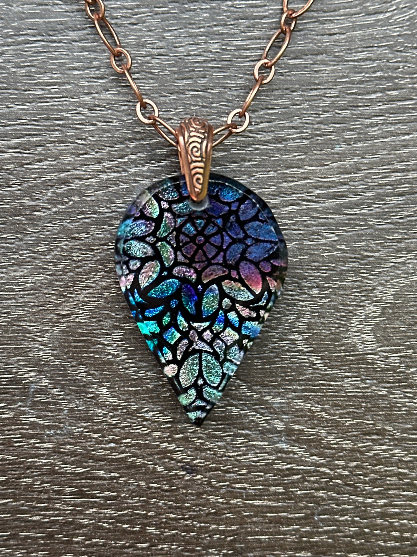 Hand etched and fused blue multicolor teardrop dichroic glass pendant with stained glass appearance.