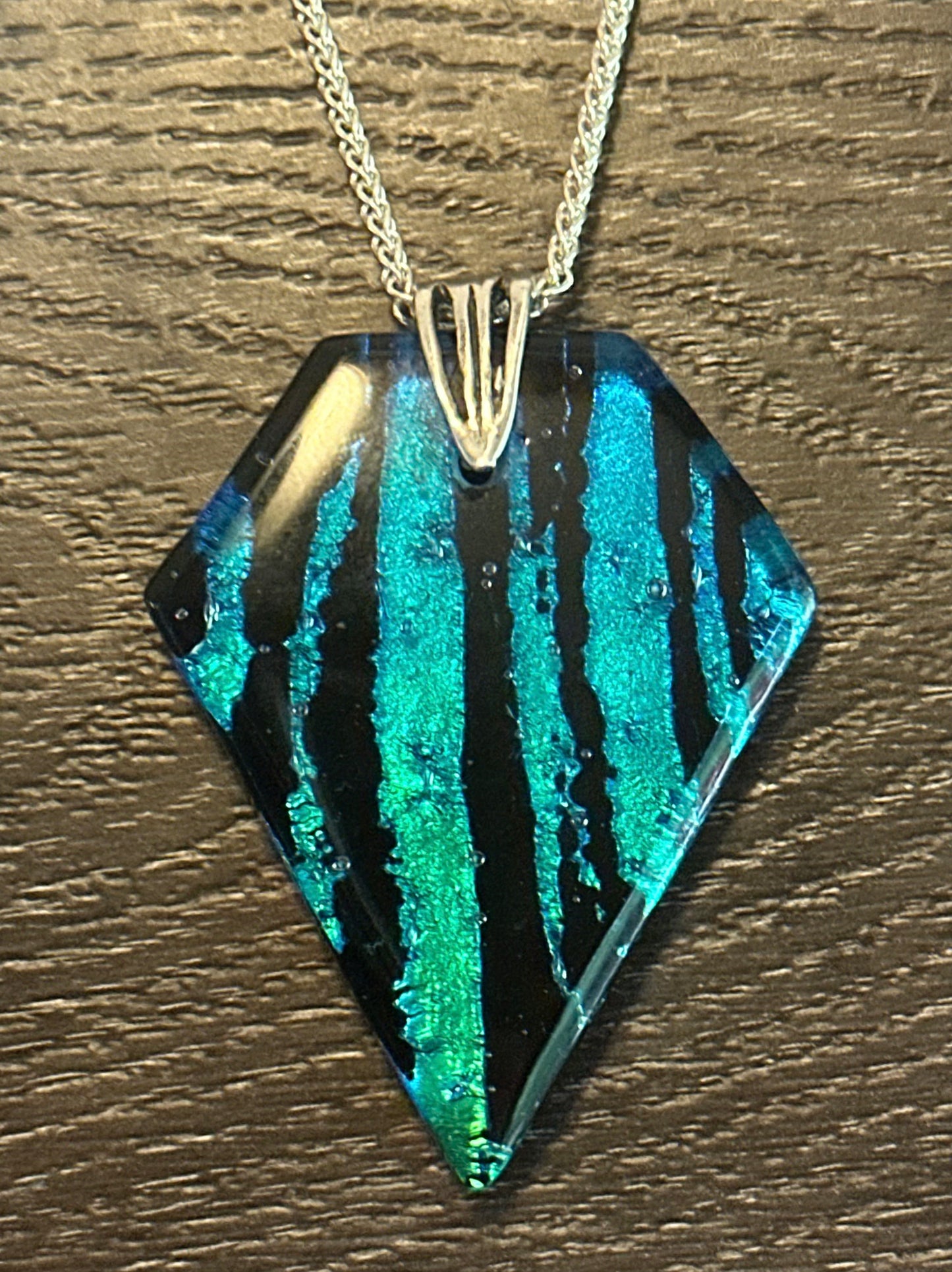 Hand etched and fused blue, teal, green and black multicolor dichroic glass pendant with sterling silver bail and wheat chain.