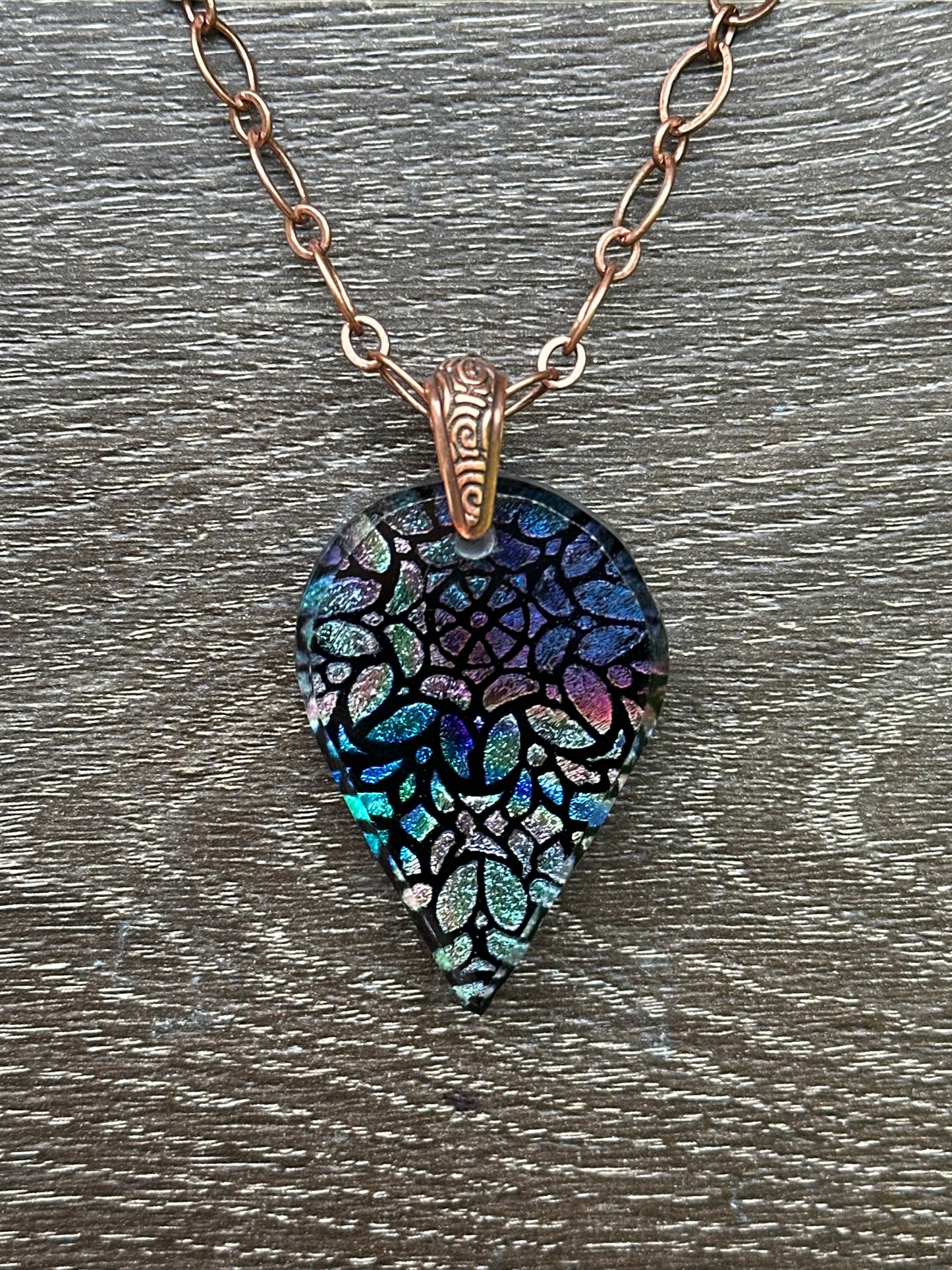 Hand etched and fused blue multicolor teardrop dichroic glass pendant with stained glass appearance.