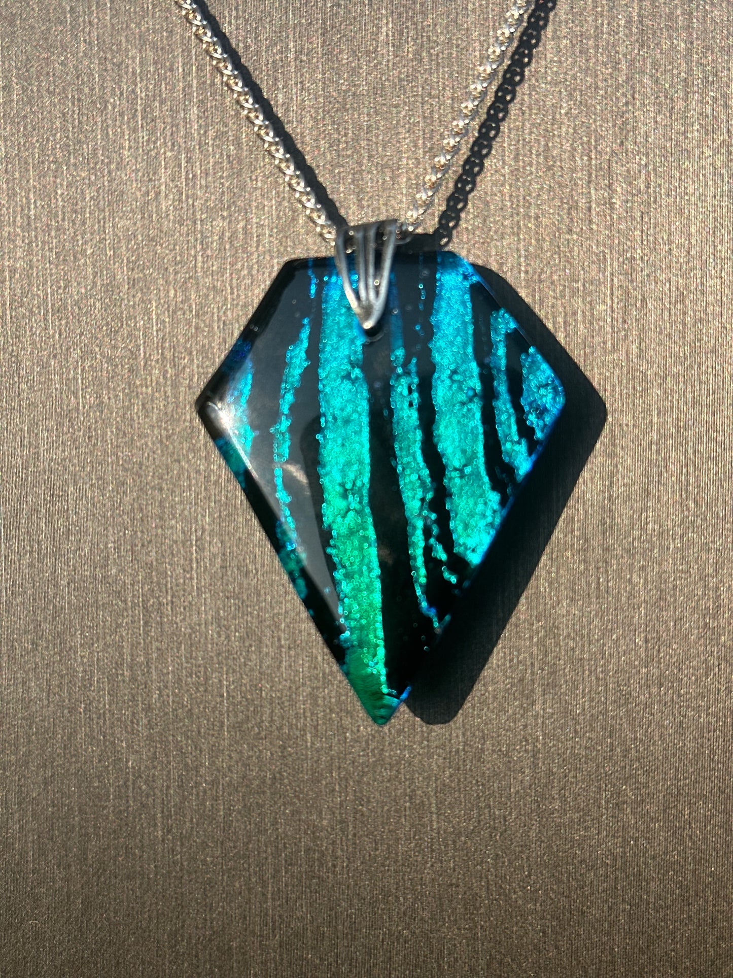 Hand etched and fused blue, teal, green and black multicolor dichroic glass pendant with sterling silver bail and wheat chain.