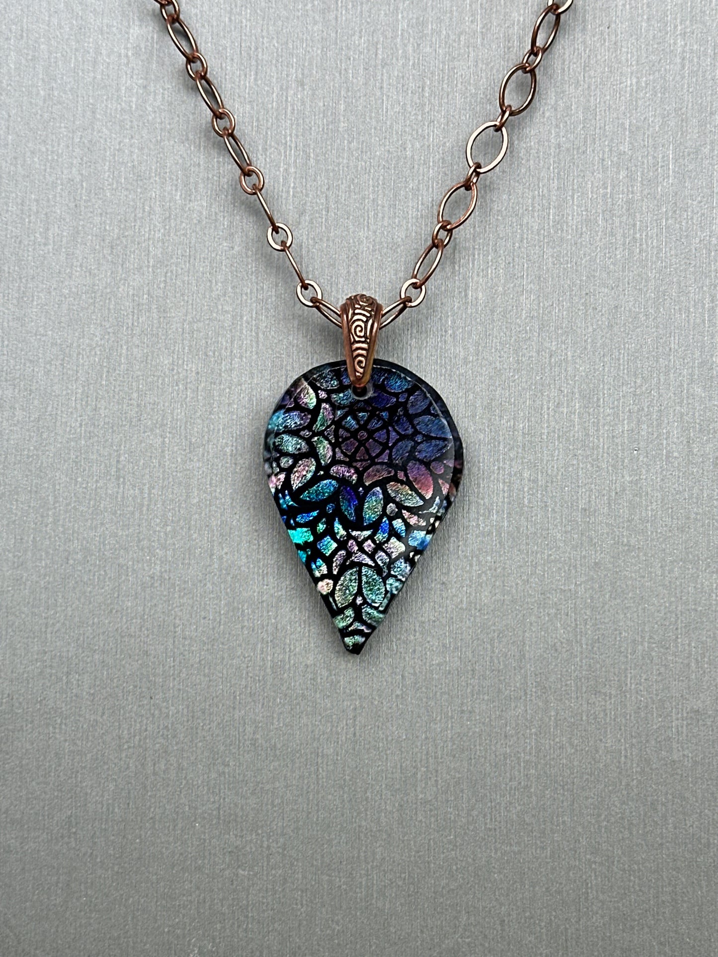 Hand etched and fused blue multicolor teardrop dichroic glass pendant with stained glass appearance.