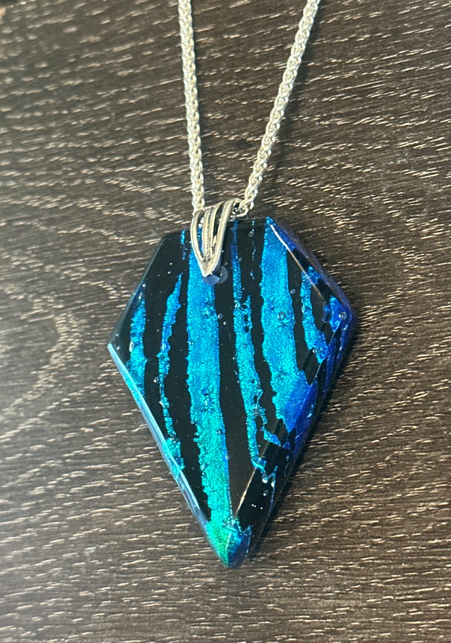 Hand etched and fused blue, teal, green and black multicolor dichroic glass pendant with sterling silver bail and wheat chain.