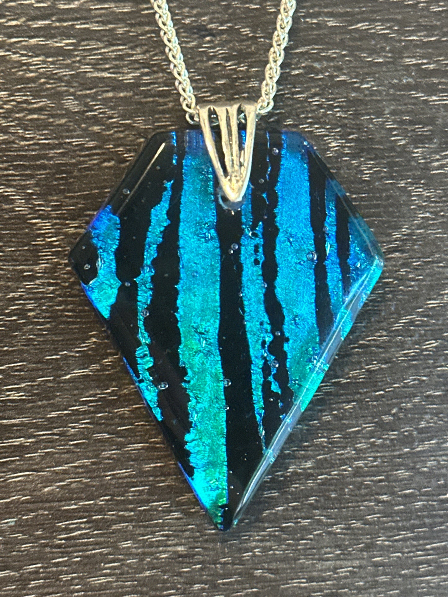 Hand etched and fused blue, teal, green and black multicolor dichroic glass pendant with sterling silver bail and wheat chain.