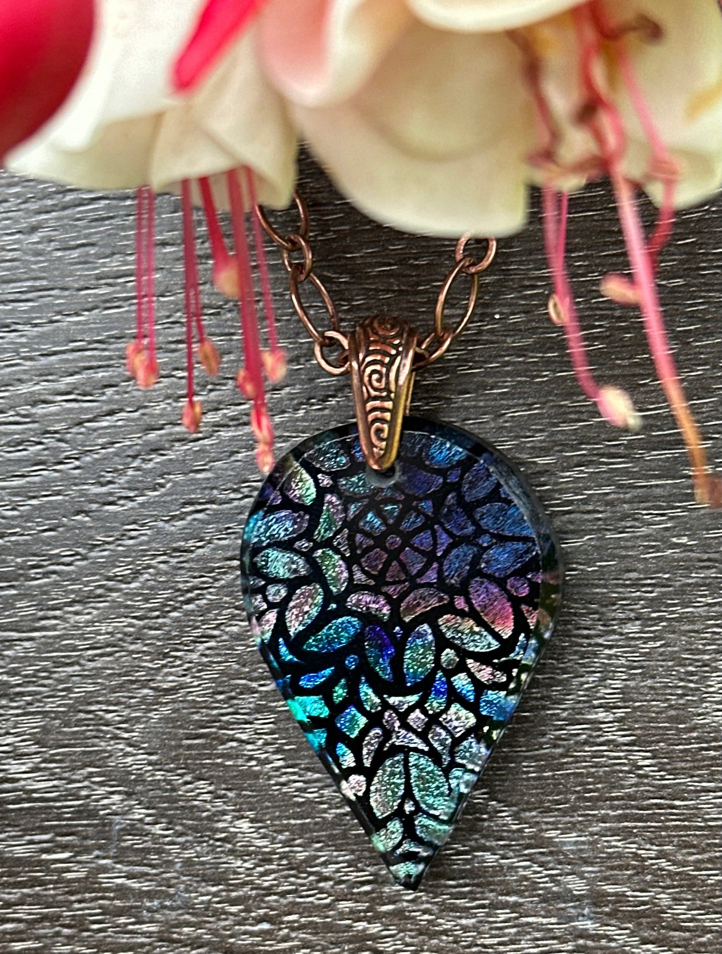 Hand etched and fused blue multicolor teardrop dichroic glass pendant with stained glass appearance.