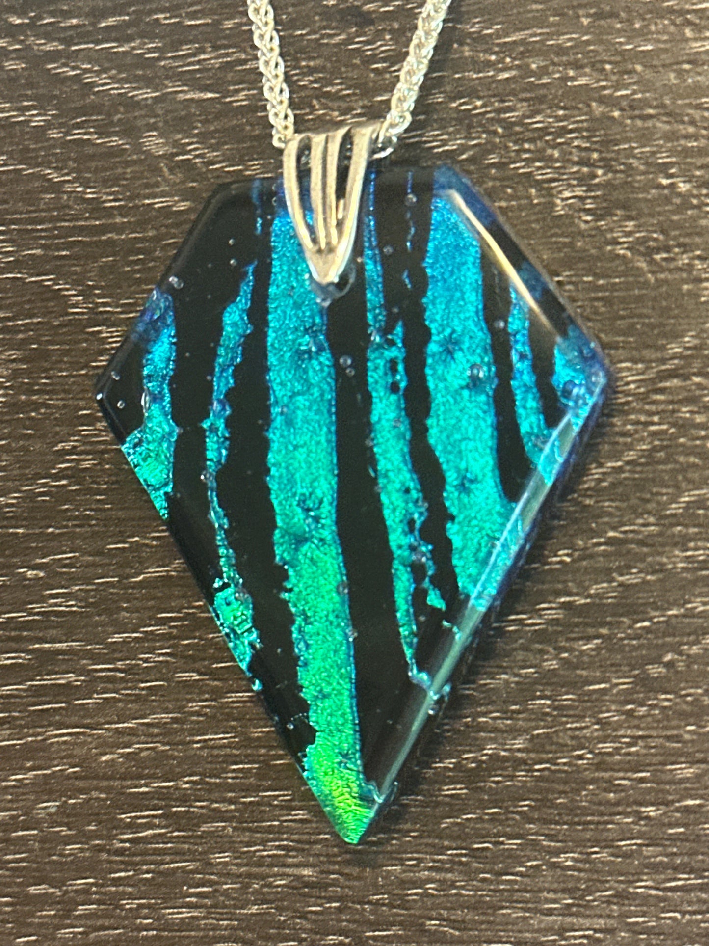 Hand etched and fused blue, teal, green and black multicolor dichroic glass pendant with sterling silver bail and wheat chain.