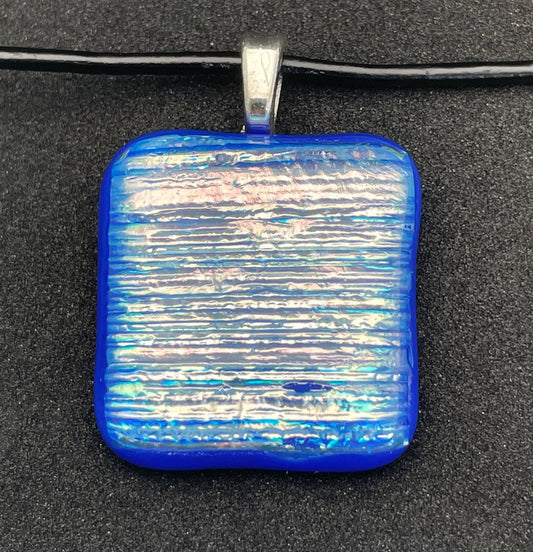 Blue, pink, gold, silver square dichroic glass pendant with leather cord.