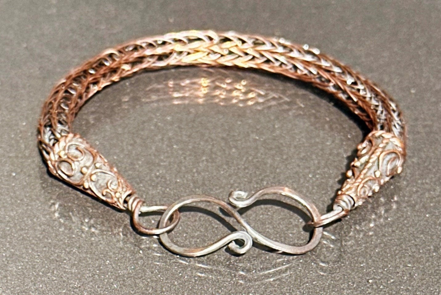 Viking knit copper bracelet with beautiful end caps.