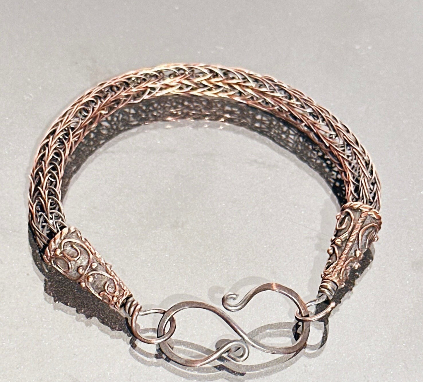 Viking knit copper bracelet with beautiful end caps.