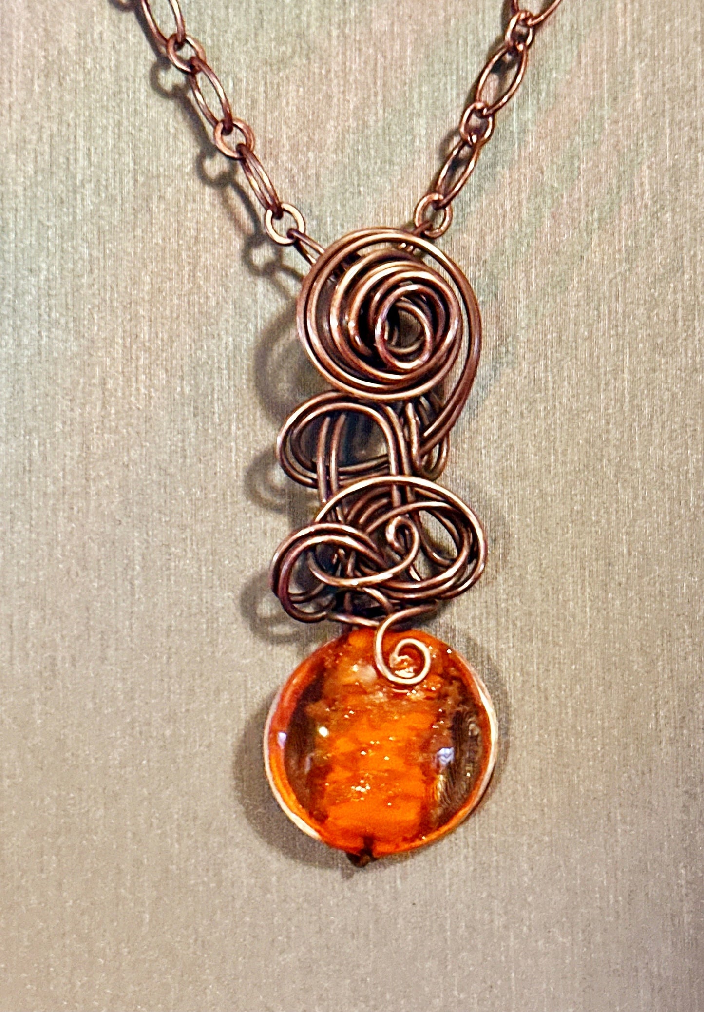 Orange glass bead with copper glitter flecks and copper freeform pendant