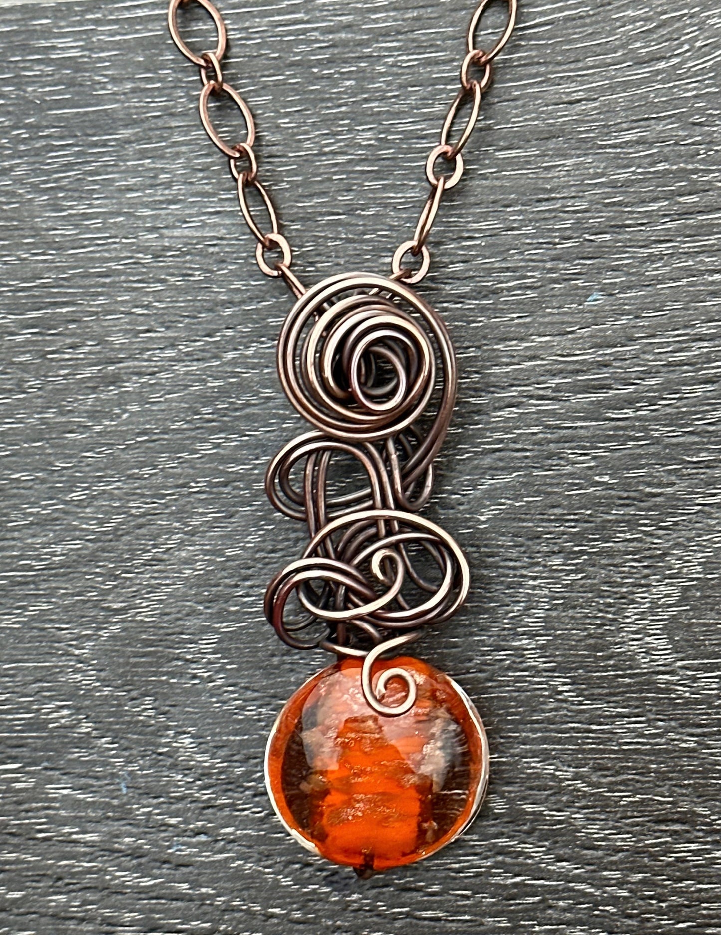 Orange glass bead with copper glitter flecks and copper freeform pendant