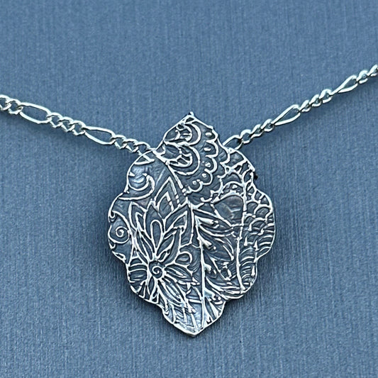 Fine silver arabesque pendant with sterling silver chain.