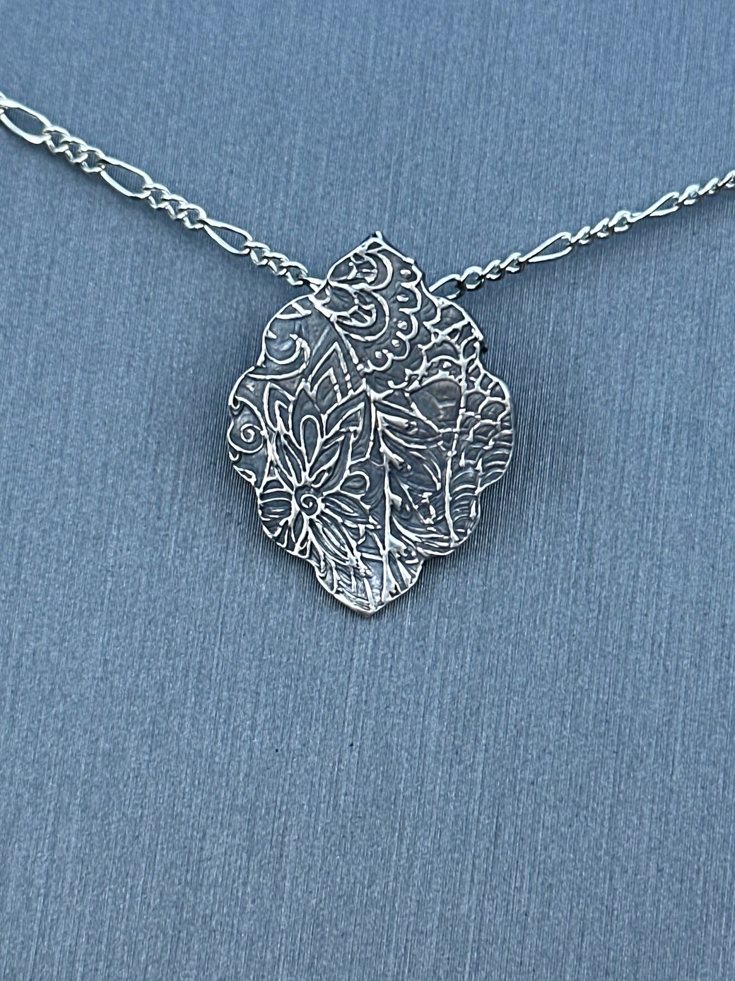 Fine silver arabesque pendant with sterling silver chain.